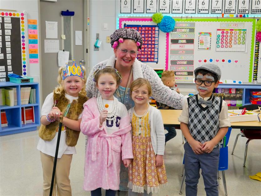 students and teacher in classroom dressed as 100 year olds